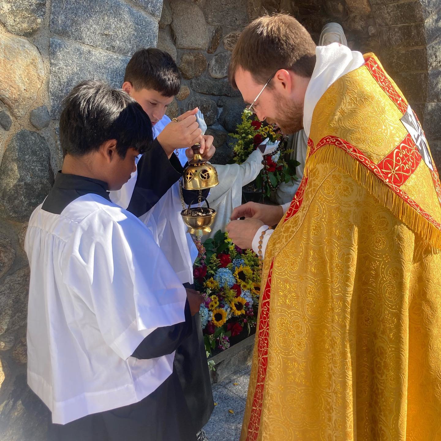 Father Dunlevy, presides of the procession, with assistance from altar servers, pictured here, Kolbe Coolman, grade 6, and Anthony Thibeault, grade 7.